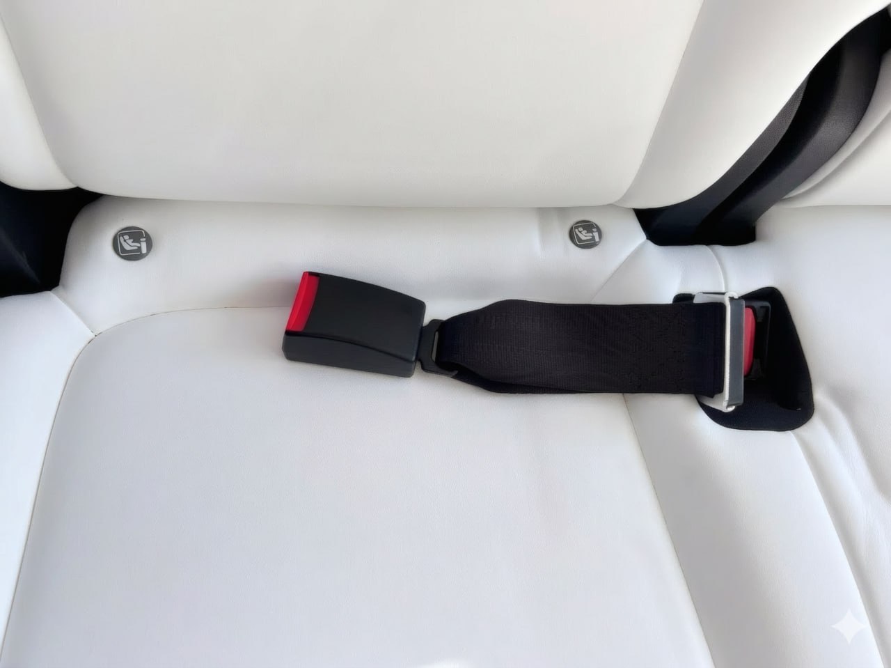 Tesla seat belt extender installed on white seat